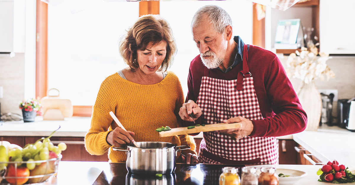 Senior couple cooking a healthy meal to help with blood sugar regulation